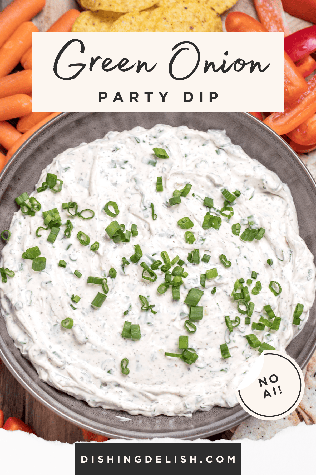Pinterest pin with a bowl of green onion dip topped with chopped green onion, resting on a cutting board, surrounded by sliced bell pepper, crackers, baby carrots, and tortilla chips.