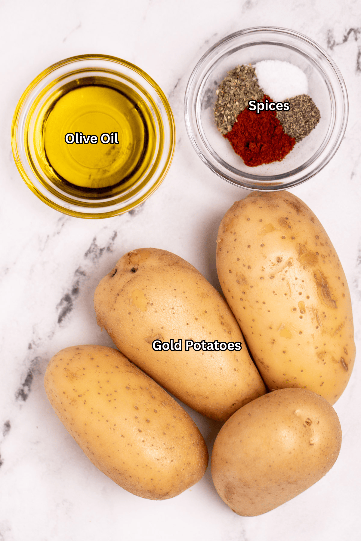 Individual ingredients for grilled potatoes on a table.