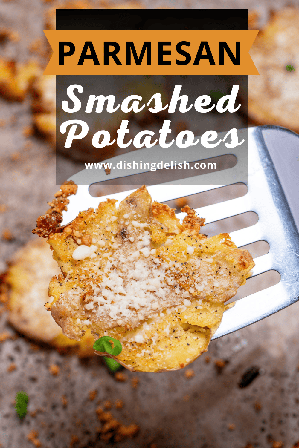 Pinterest pin with a spatula lifting up a crispy garlic parmesan smashed potato.
