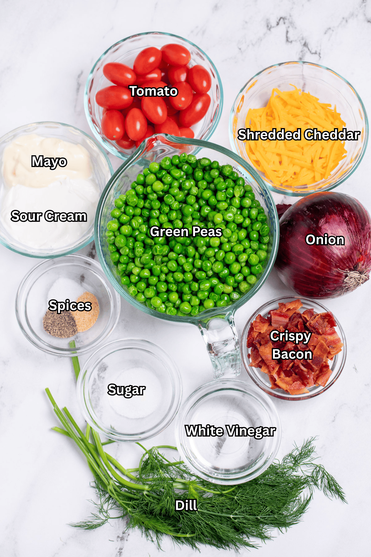 Individual ingredients for green pea salad on a table.
