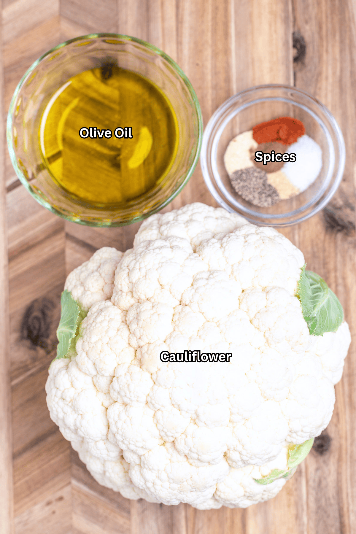 Individual ingredients for grilled cauliflower steaks on a table.