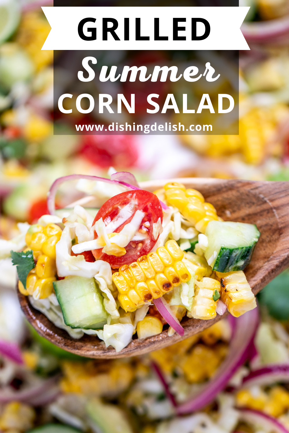 Pinterest pin with a serving bowl full of summer corn salad with corn, avocado, red onion, cilantro, cabbage, and lime wedges, with a spoon lifting some up.