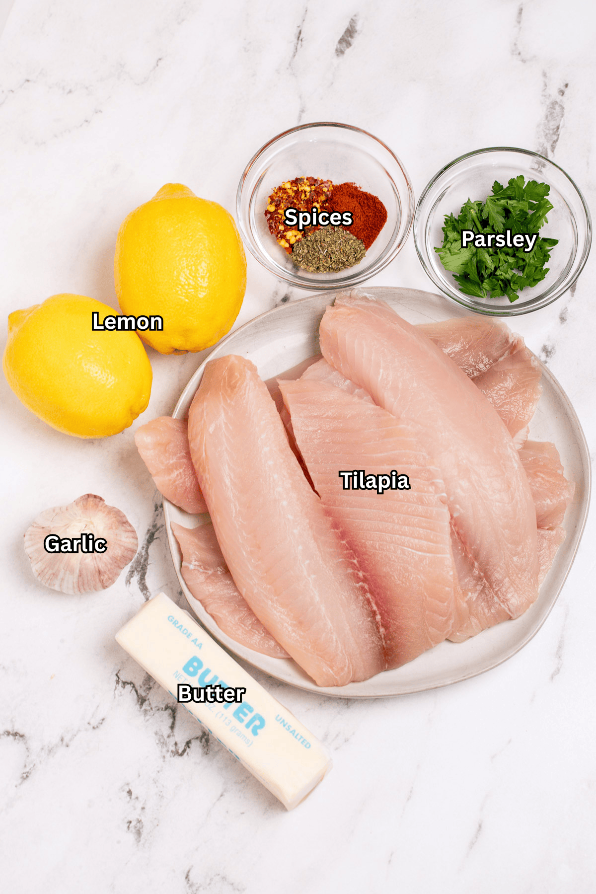 Individual ingredients for oven baked tilapia on a table.