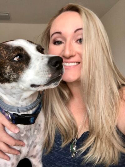 Jacqui and her dog Gwen sitting side by side.