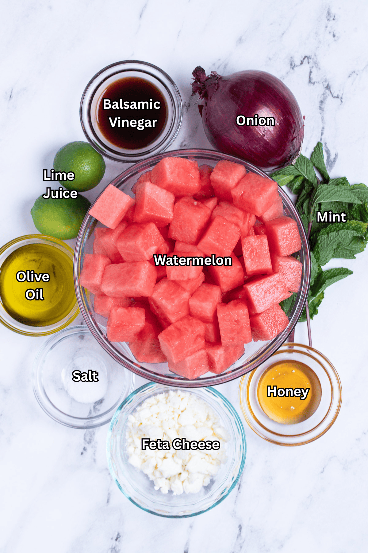 Individual ingredients for watermelon feta salad on a table.