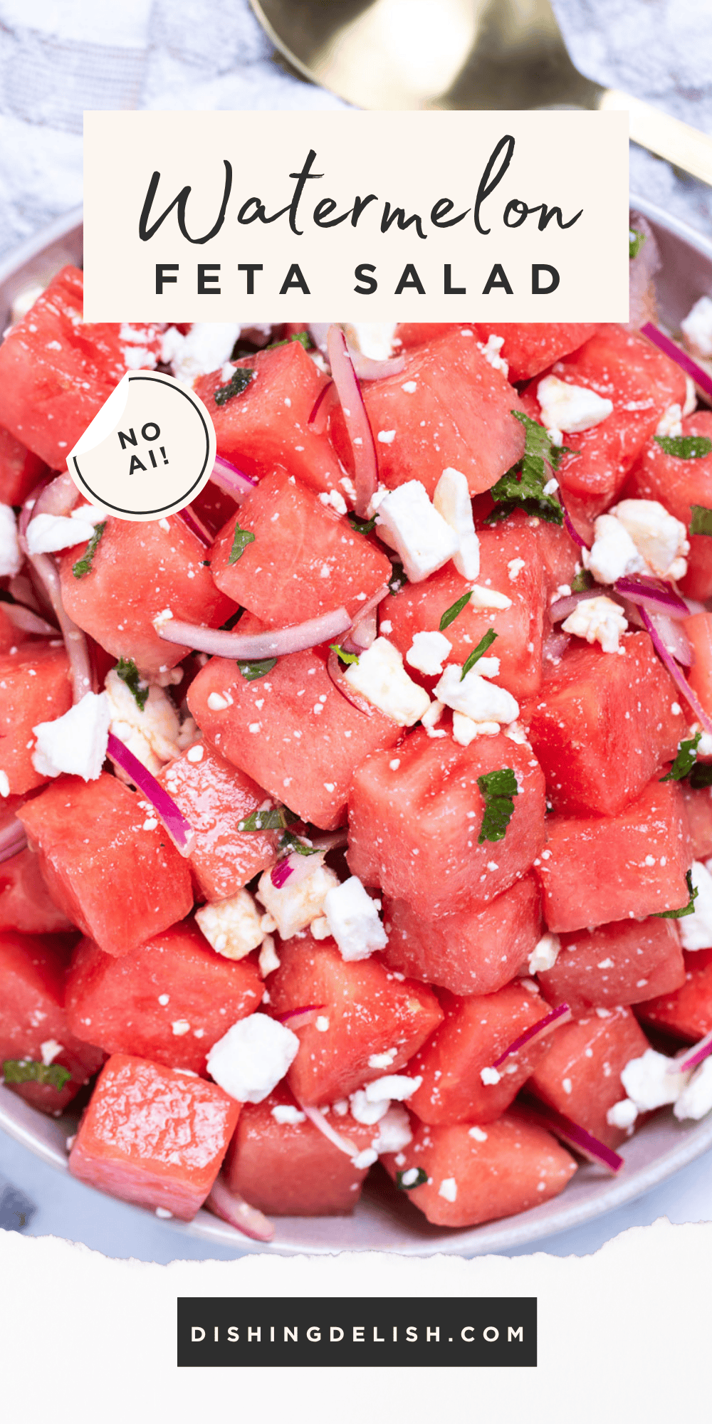 Pinterest pin with watermelon feta salad in a bowl on a table next to a serving spoon and a tea towel.