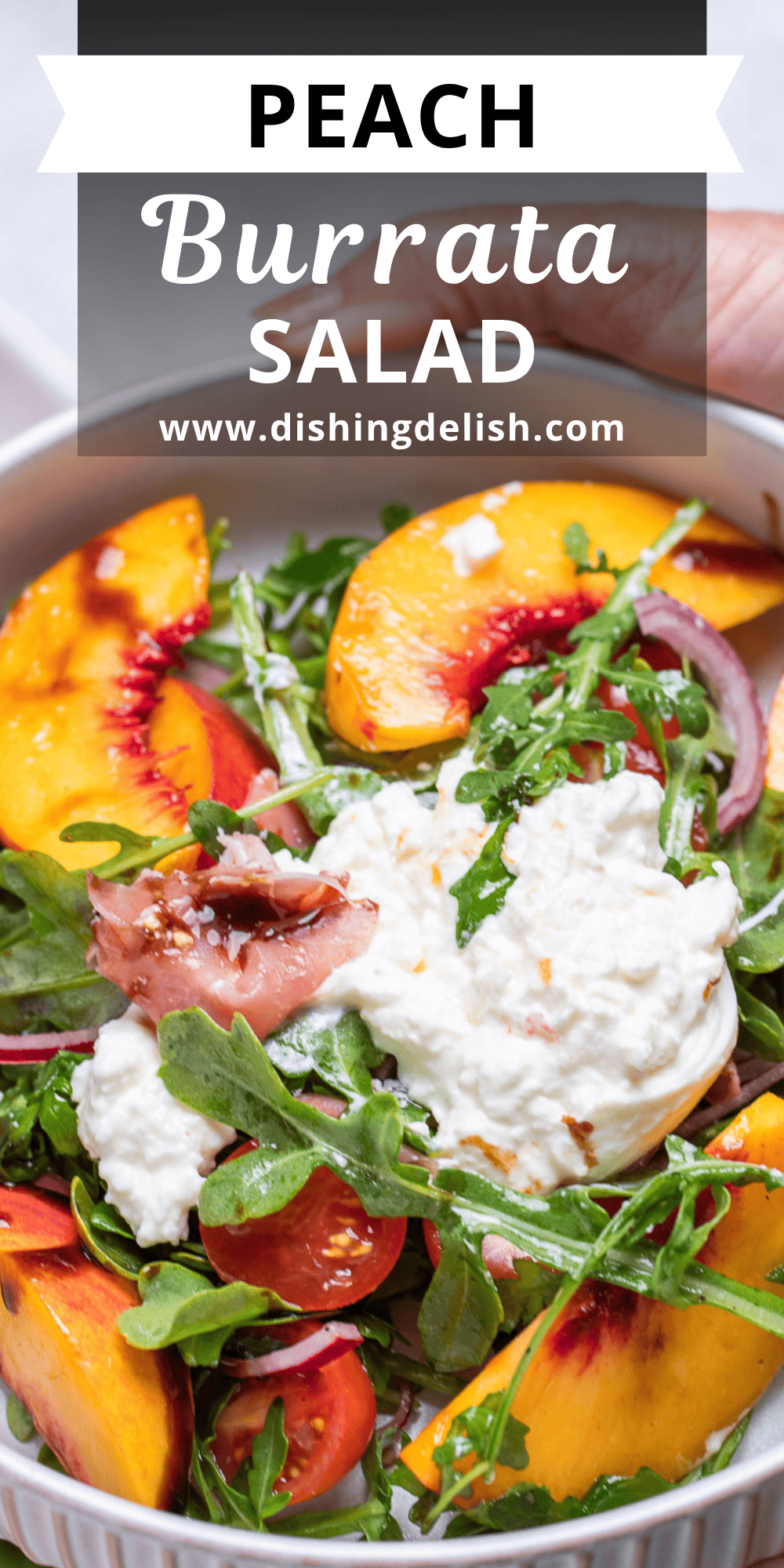 Pinterest pin with hands holding a bowl with peach burrata salad, with arugula, cherry tomatoes, red onion, peach slices, and burrata on top.
