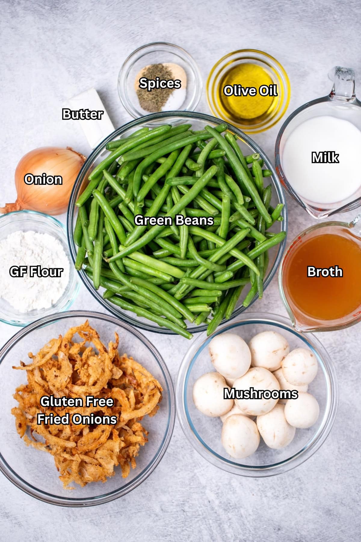 Individual ingredients for gluten free green bean casserole from scratch on a table.