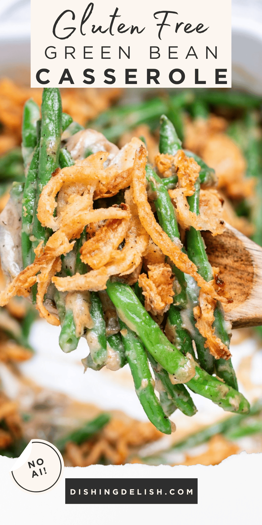 Pinterest pin with a wooden serving spoon lifting up some green bean casserole from a baking dish, with crispy fried onions on top.