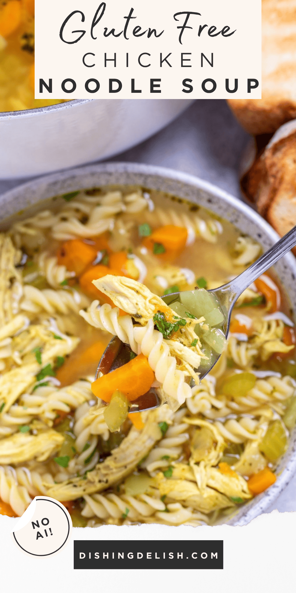 Pinterest pin with a bowl of gluten free chicken noodle soup in front of a dutch oven and toasted bread, with a spoon lifting some up.