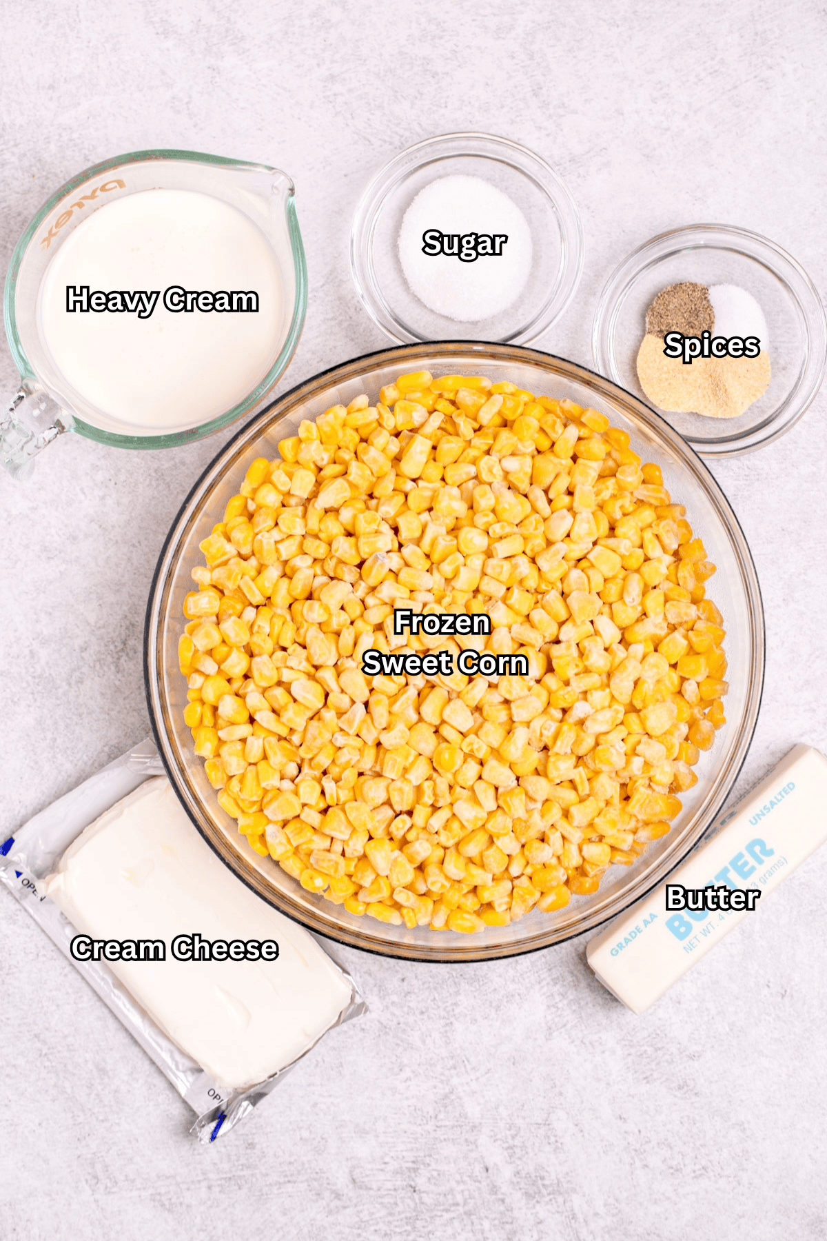 Individual ingredients for slow cooker creamed corn on a table.
