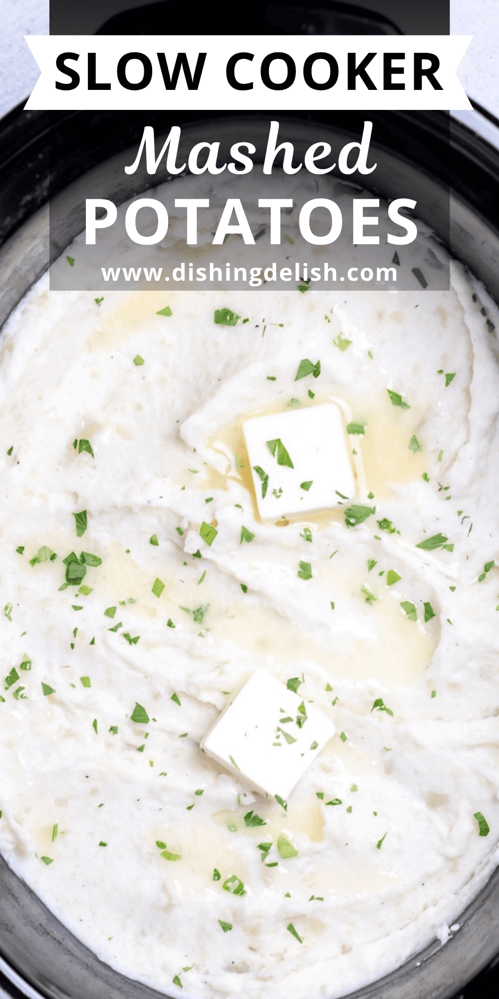 A slow cooker full of mashed potatoes topped with chopped parsley and butter.